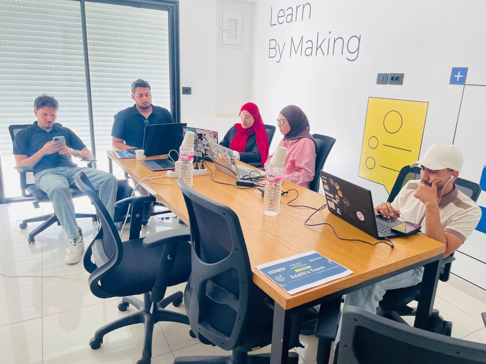 Participants building and following the hackathon at Sousse.