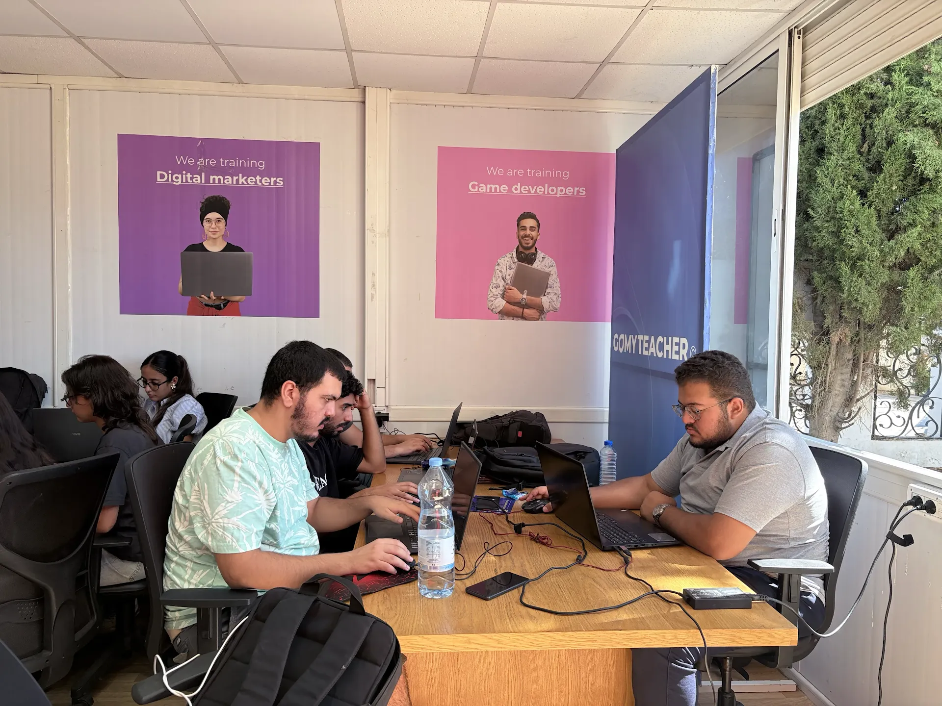Participants collaborating with laptops during Come Build with AI.