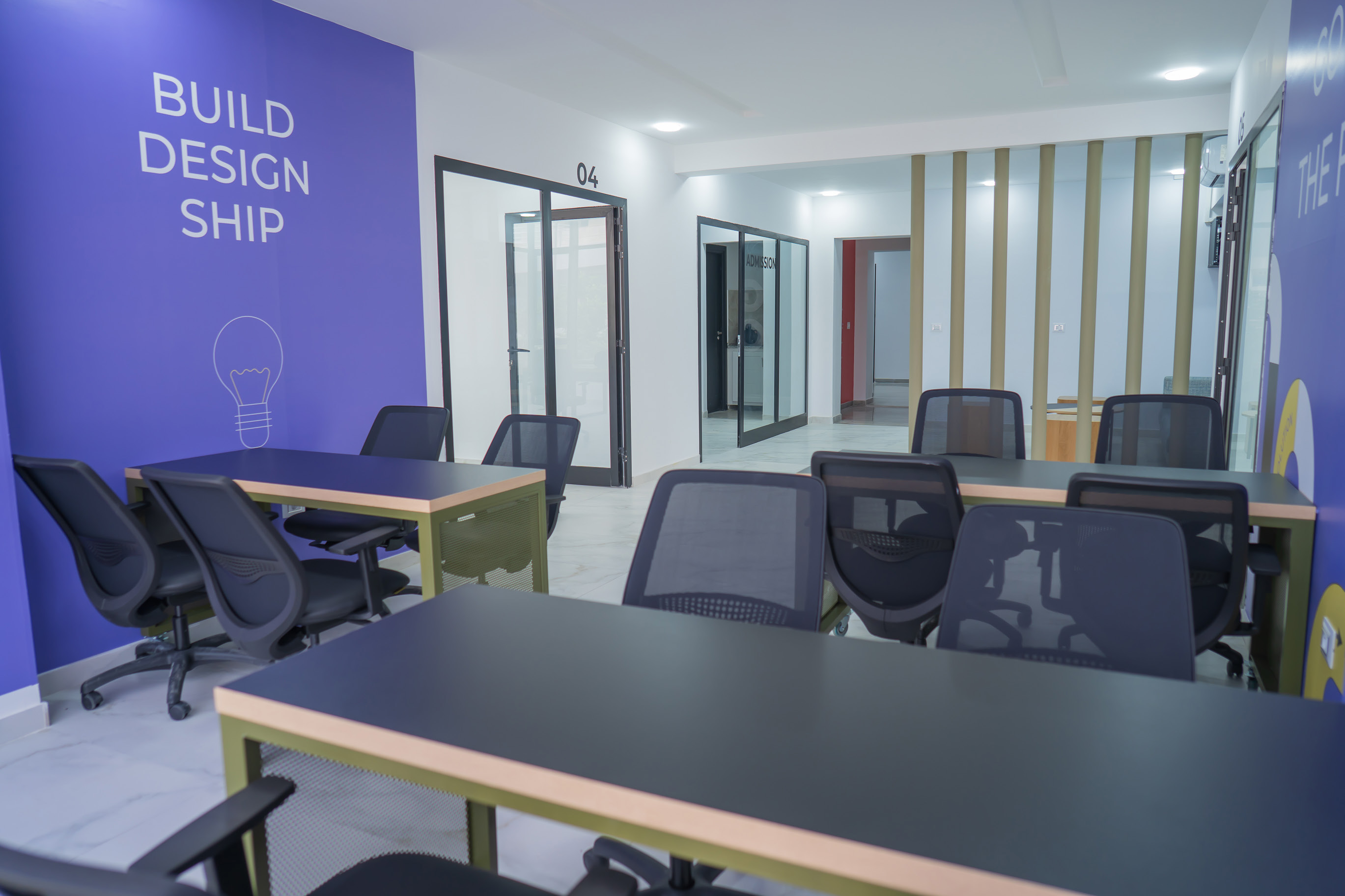 Purple GOMYCODE classroom designed for building and teamwork